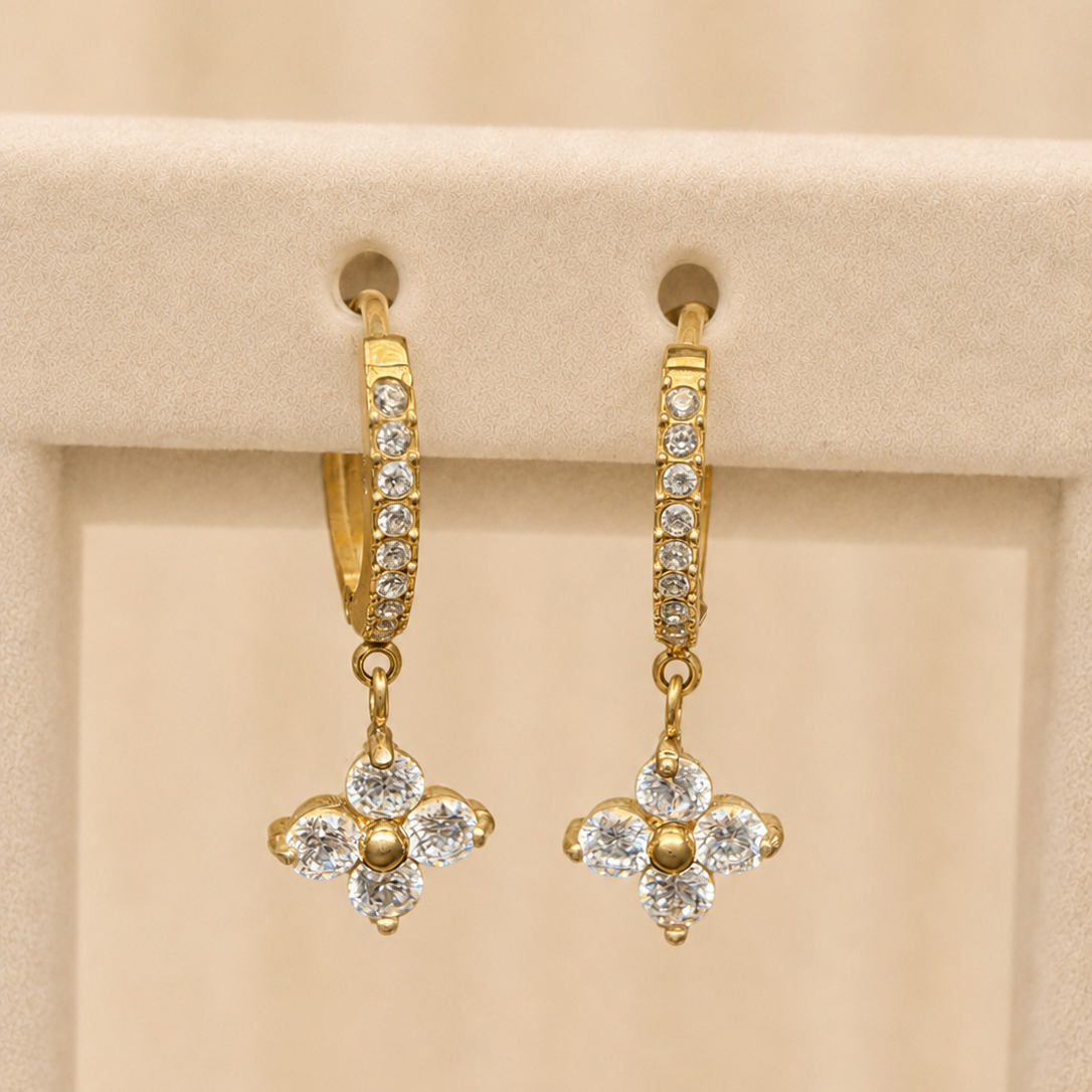 Chamak pavé huggie hoop earrings with a four-petal crystal flower drop, in gold